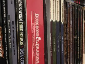 A row of role-playing game books on a shelf