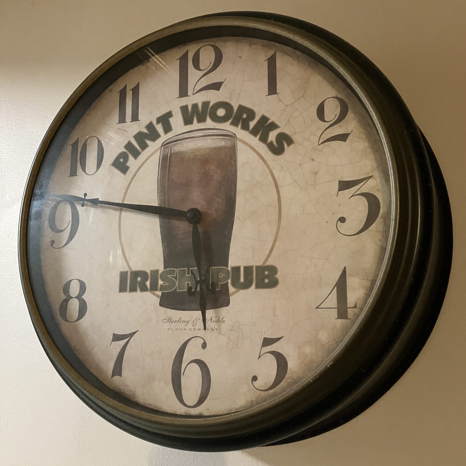 A wall clock displaying a time of about 5:46, the face has a pint of beer and reads, "Pint Works Irish Pub"